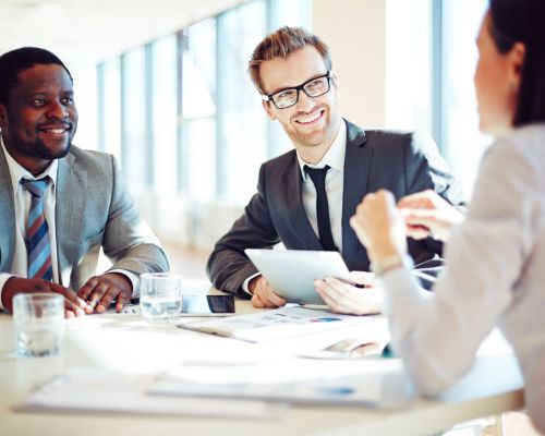 Smiling colleagues discussing working ideas in office